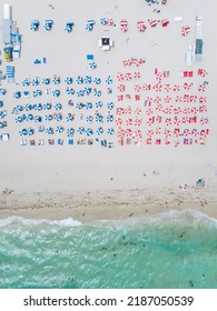 Drone Aerial View At Miami South Beach Florida. Beach With Colorful Chairs And Umbrellas, Top View Of The Beach Miami Florida