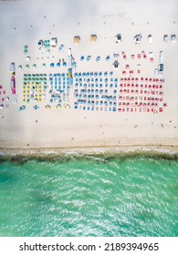 Drone Aerial View At Miami South Beach Florida. Beach With Colorful Chairs And Umbrellas, Top View Of The Beach Miami Florida