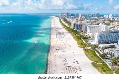 Drone Aerial View At Miami South Beach Florida. Beach With Colorful Chairs And Umbrellas, Top View Of The Beach Miami Florida