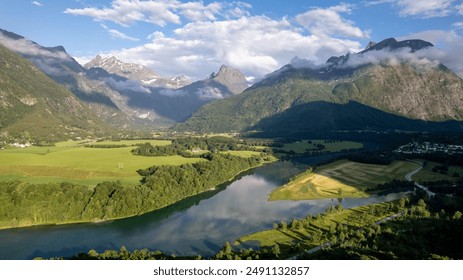 drone aerial view over fjord and mountains in Andalsnes with the sunset and lake, summer in Norway countryside Rauma - Powered by Shutterstock