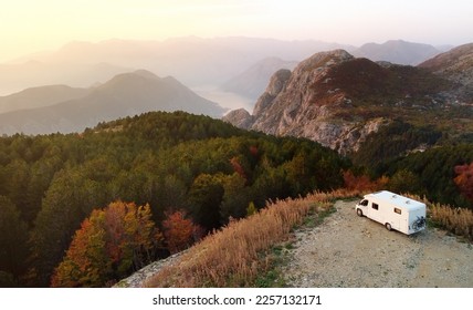 Drone aerial view of parked big modern camper motorhome. Family vacation travel RV. Bicycles attached to a caravan. Travel and adventure. Go everywhere concept. - Powered by Shutterstock