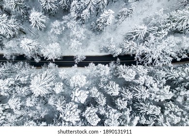 Drone Aerial View Of Road In The Snowy Forest. Vilnius County, Lithuania