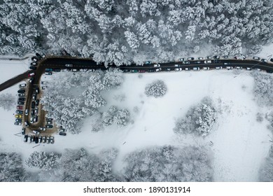 Drone Aerial View Of Road In The Snowy Forest. Vilnius County, Lithuania