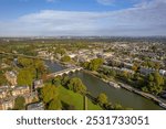 The drone aerial view of Thames river runs through Richmond town centre on the east bank with its neighbouring district of East Twickenham to the west, London.