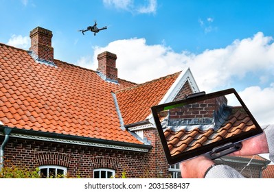 Drone in the air inspecting the roof over the house. Close-up of drone and roof. - Shutterstock ID 2031588437