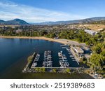 A drone areial view overleooking the marina and Skaha Beach on Skaha Lake, located in the city of Penticton, British Columbia, Canada. Penticton is located in the Okanagan Valley.