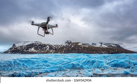 Drone with a camera is flying on iceberg.