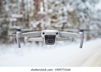 Drone with camera flying in the winter forest