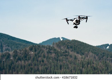 Drone with camera hovering over mountains/flying drone with camera