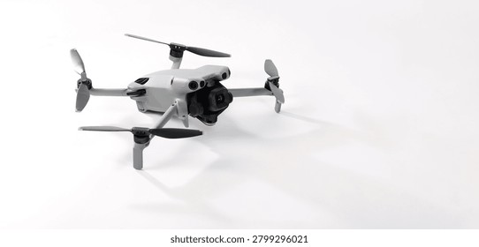 Drone camera. Modern camera drone with remote controller on white background. UAV or Unmanned Aerial Vehical technology for aerial photography videography mapping inspection and recreational flying.