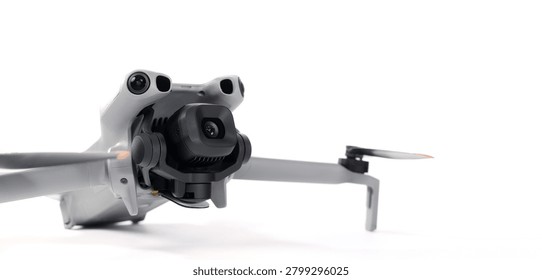 Drone camera. Modern camera drone with remote controller on white background. UAV or Unmanned Aerial Vehical technology for aerial photography videography mapping inspection and recreational flying.