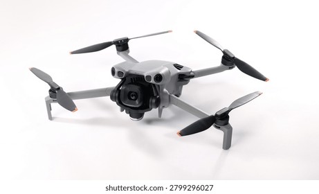 Drone camera. Modern camera drone with remote controller on white background. UAV or Unmanned Aerial Vehical technology for aerial photography videography mapping inspection and recreational flying.