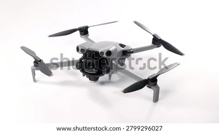 Drone camera. Modern camera drone with remote controller on white background. UAV or Unmanned Aerial Vehical technology for aerial photography videography mapping inspection and recreational flying.