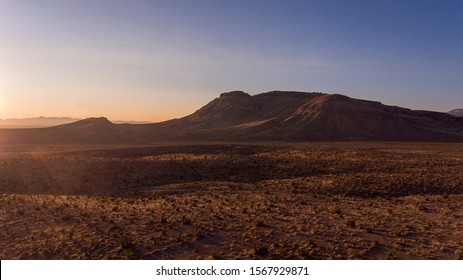 A Drone Captures Aerial Footage Of The Sunrise Over The Nevada Desert And Mountains.