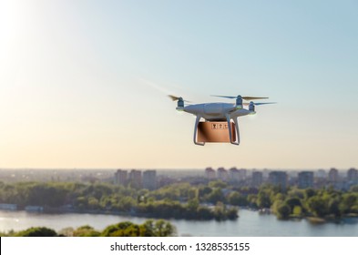 Drone Carrying Delivering Package , City In Background