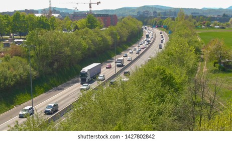 DRONE: Cars And Truck Cruise Along The Busy Highway During Afternoon Rush Hour. Flying Along A Crowded Freeway During A Traffic Jam On A Sunny Day. Tourists And Commuters Occupy The Freeway In Summer.