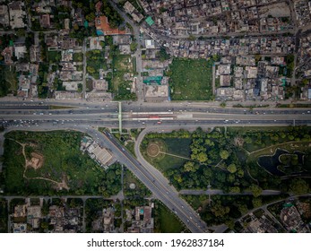 Drone Cityscape Of Lahore Metro Bus Ferozpur Road With Traffic, Buildings And Parks