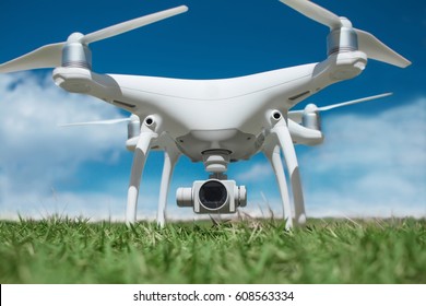 Drone close-up in the grass preparing to fly, blue sky background