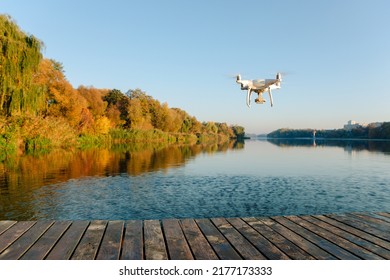 Drone copter with digital camera, blur river on background