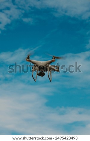 drone copter flying with digital camera in sky .blue sky as background.