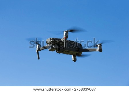 The drone copter flying with digital camera.