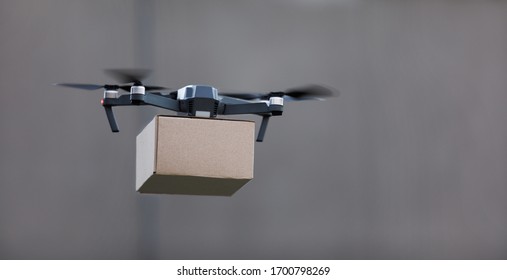 Drone Delivery System. Quadcopter Delivering Pracel By Air To People, Panorama, Copy Space, Gray Background