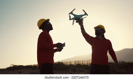 Drone engineers working on construction site - Aerial engineering concept