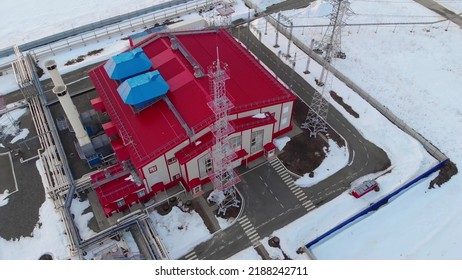 The Drone Flies Around A Gas Turbine Power Plant With A Red Roof And Pipes In The Winter. The Use Of Natural Gas In Winter In Industry And For Electricity Generation And Heating.