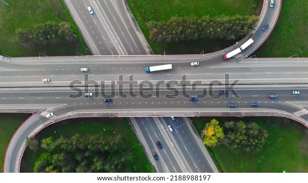 The drone flies over the track during traffic with
many interchanges in different directions with a large number of
cars that move one after another and change lanes to the desired
exit from the