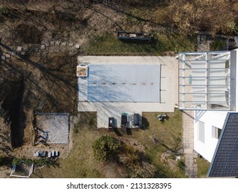 Drone Flight Over A Covered Pool With A Tarp That Is Still Under Construction In A Garden