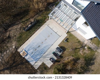 Drone Flight Over A Covered Pool With A Tarp That Is Still Under Construction In A Garden