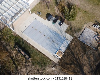 Drone Flight Over A Covered Pool With A Tarp That Is Still Under Construction In A Garden