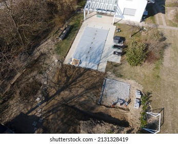 Drone Flight Over A Covered Pool With A Tarp That Is Still Under Construction In A Garden