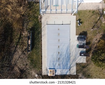 Drone Flight Over A Covered Pool With A Tarp That Is Still Under Construction In A Garden