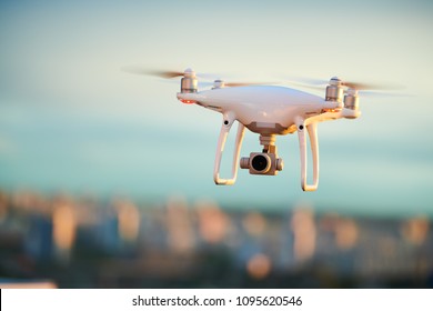 drone flying over evening city with digital camera