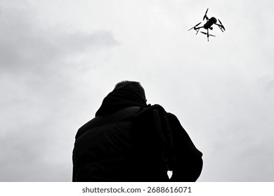 Drone is flying in the sky. Operator controls the drone. War in Ukraine - Powered by Shutterstock - Get 15% off with code: PIKWIZARD15