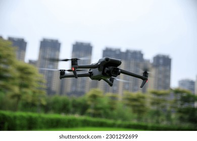 Drone flying  in spring city park - Powered by Shutterstock