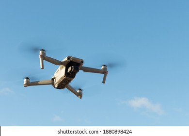 Drone flying under clear blue sky