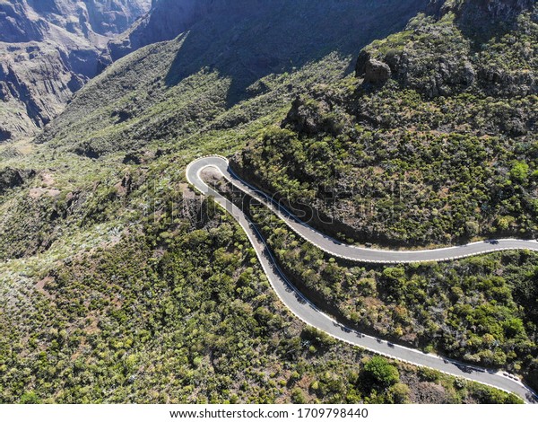 Drone footage of the curved road in\
nearby the Masca village on the Canary Islands,\
Spain