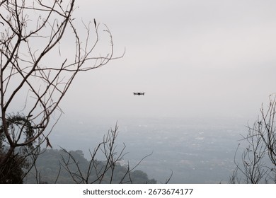 Drone Hovering Above Forest Trees