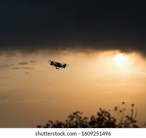 Drone hovering in the sky during sunset