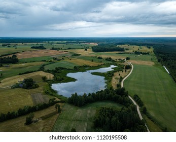 Drone Image. Aerial View Of Rural Area With Houses And Roads Under Heavy And Dark Dramatic Rain Clouds In Summer Day. Night Photo. Latvia