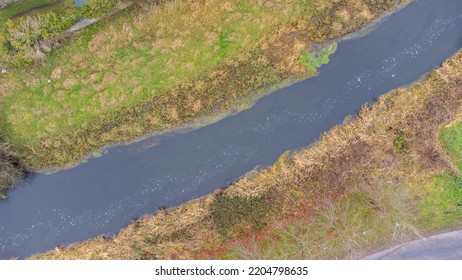 Drone Image. Aerial View Of Rural Area With River Taken Diagonaly Of The Image.