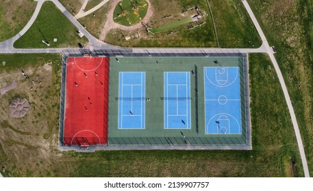 Drone image looking down onto tennis courts and a basketball court.