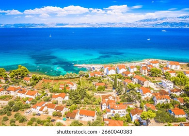 Drone image of Mirca on Brac island showing clustered stone houses, tiled roofs, narrow streets and calm Adriatic shoreline in a quiet Mediterranean village setting under clear sky
