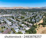 Drone images over a small community in Concord, California with dead hills and apartment buildings