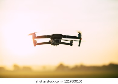 Drone like Mavic 2 Pro flying during sunset.