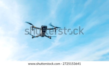 Drone machine with blue sky background for commercial marketing. Drone services for land and environmental assessment, providing reliable aerial insights.