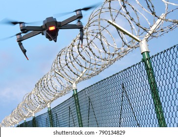 Drone monitoring barbed wire fence on state border or restricted area. Modern technology for security.