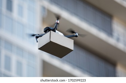 Drone Is New Tool For Delivery, Fast And Safety Air Delivery. Blurred Building On Background, Copy Space